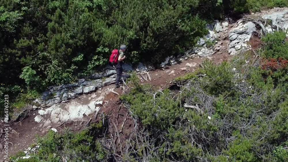 Cortina D'Ampezzo - Sorapiss Ampezzo Dolomites. Man walking along a mountain path on a sunny day. Aerial shot with a drone.
Cortina D'Ampezzo - Sorapiss Ampezzo Dolomites. Man walking along a mountain path on a sunny day. Aerial shot with a drone.