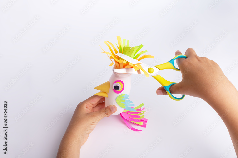 child makes a parrot craft from paper and recycled yogurt bottle, DIY ...