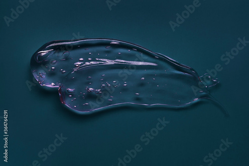 Liquid cream gel foam gommage mask cosmetic smudge texture dark blue background photo