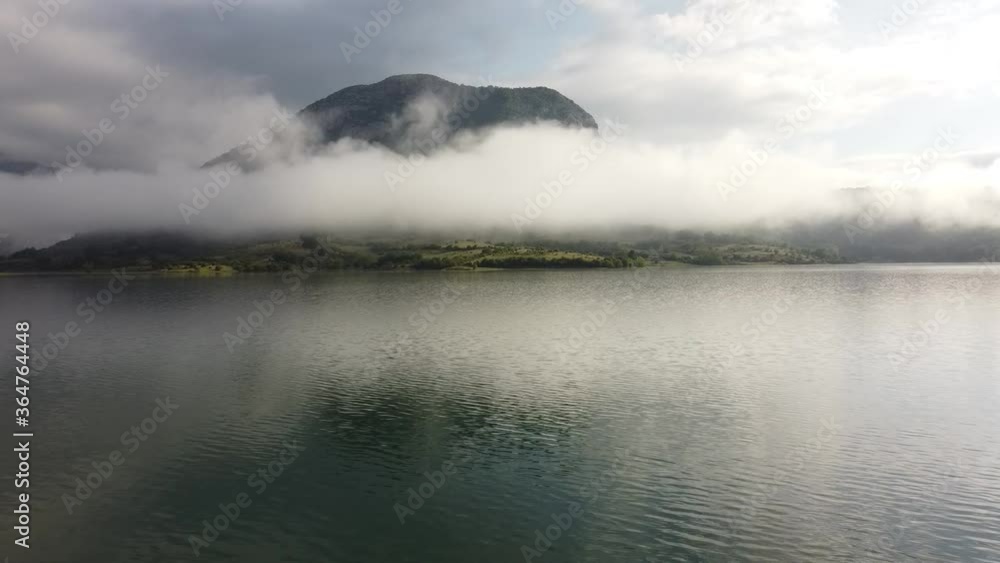 Drone view of lake in fog, mountain and island Drone view of lake in fog, mountain and island