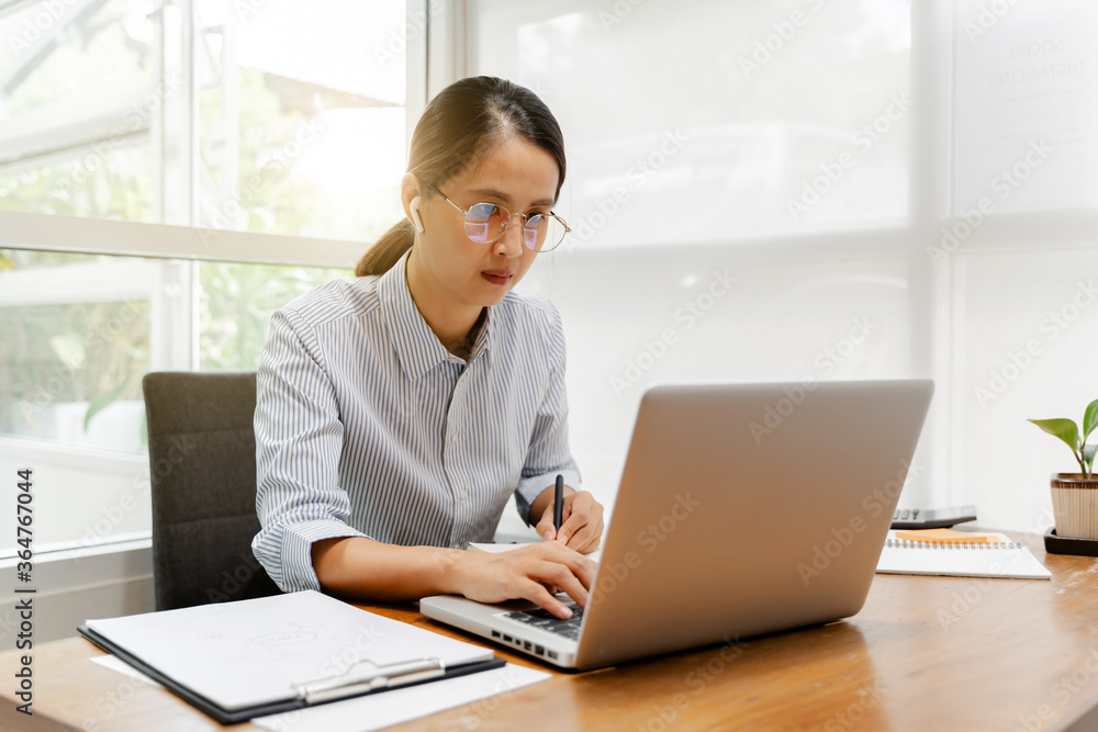 Attractive asian woman working with laptop at home. Attractive asian woman working with laptop at home.