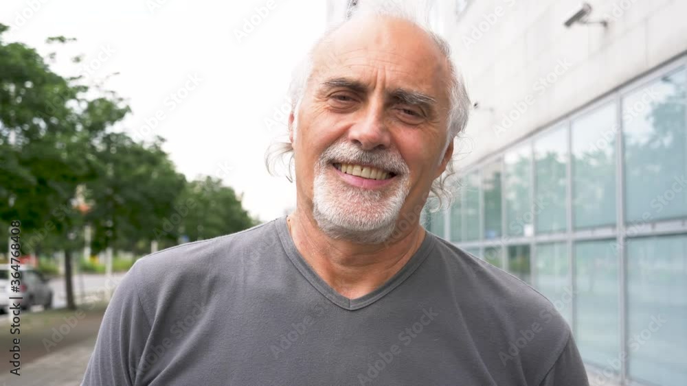 Slow motion shot of smiling senior athletic man looking at camera Slow motion shot of smiling senior athletic man looking at camera