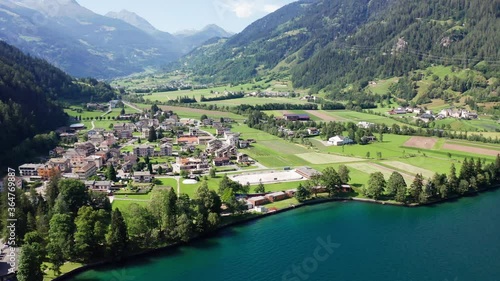 Aerial 4K - Poschiavo valley, Switzerland, view of the village Le Prese from the Poschiavo lake	
