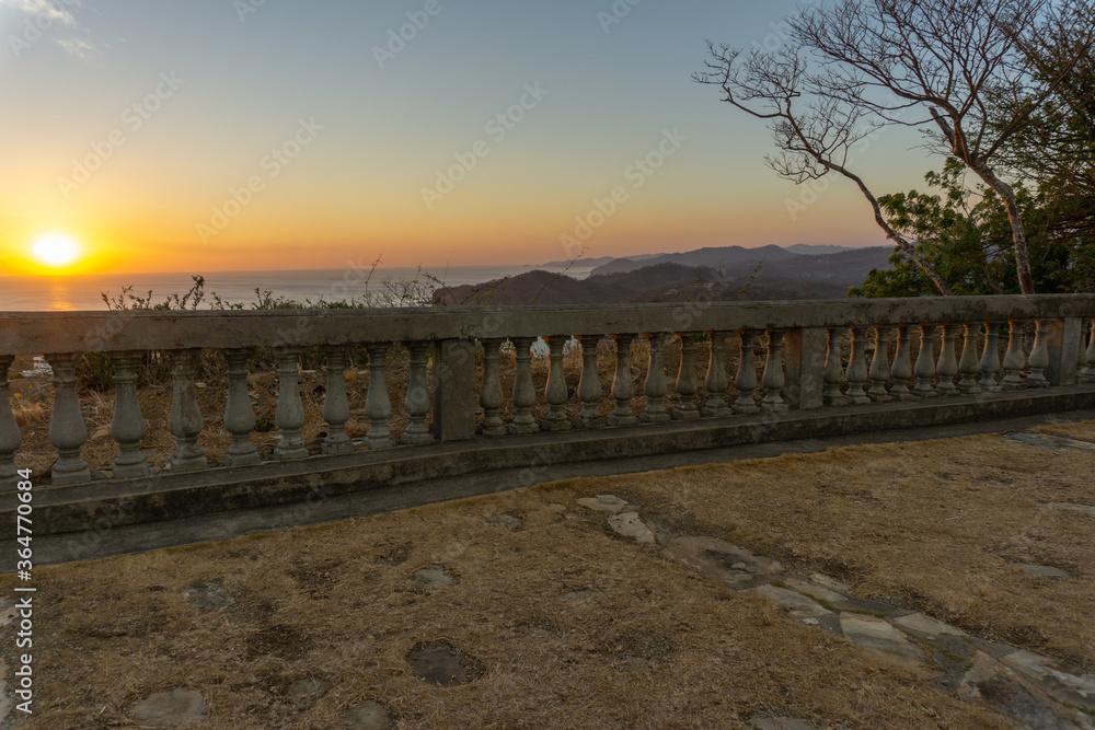 old railing at lookout point with low sun