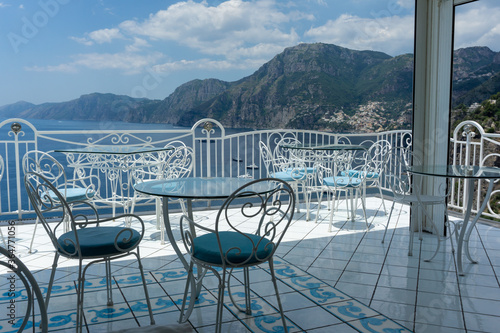 metal tables and chairs overlooking the sea in europe