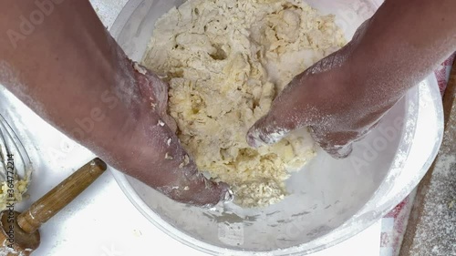 Home bakery. Girl  kneads  the dough with her hands. Process of making and whisking dough  photo