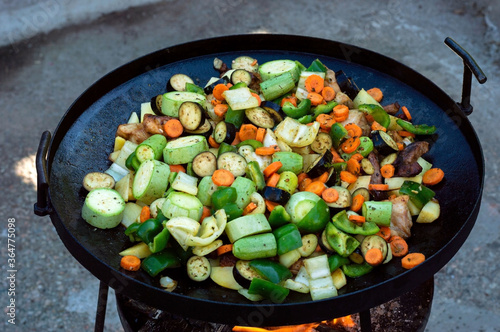 Mix of vegetables with meat in a frying pan - grill. Close up