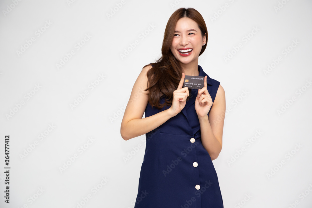 Young beautiful Asian woman smiling holding credit card isolated on white background Young beautiful Asian woman smiling holding credit card isolated on white background