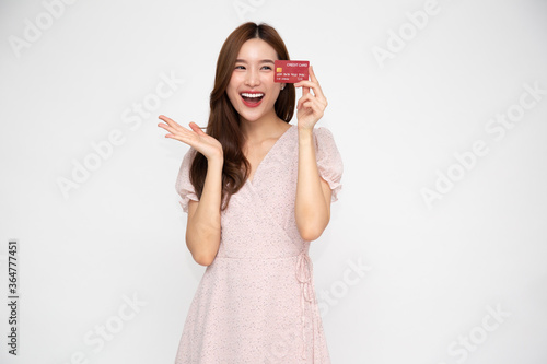 Young beautiful Asian woman smiling holding credit card isolated on white background