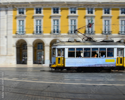 Vintage yellow tramway at the Commerce Square, in Lisbon, Portugal. Photography made using the panning technique.