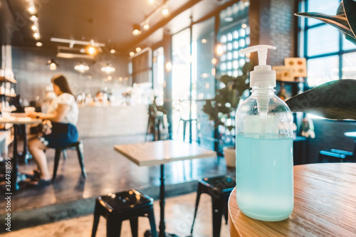 Blue alcohol gel bottle for hand cleaning to prevent the spreading of the Corona virus  Covid-19   Place the entrance service for customers  in the cafe. Healthcare concept.
