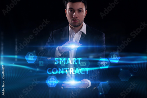 Business, Technology, Internet and network concept. Young businessman working on a virtual screen of the future and sees the inscription: Smart contract