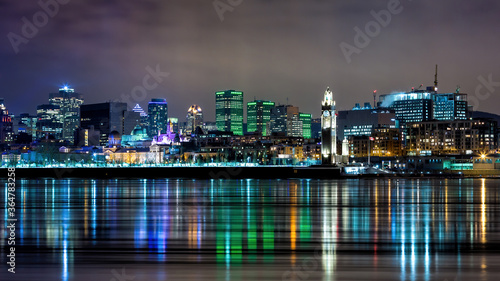 Downtown Montreal in winter. Night shot with reflected city light in the St Lawrence river.