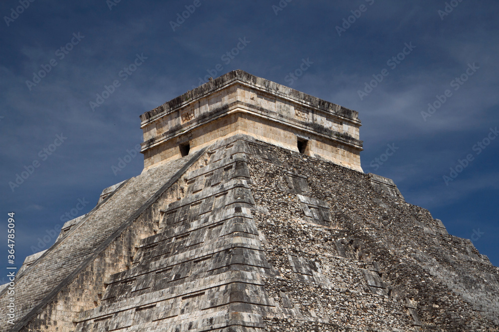 Tourism. Seven world wonders. Ancient maya civilization and architecture. Closeup of temple Kukulkan of Chichén Itza, mayan stone pyramid apex ruins in Yucatán, México.