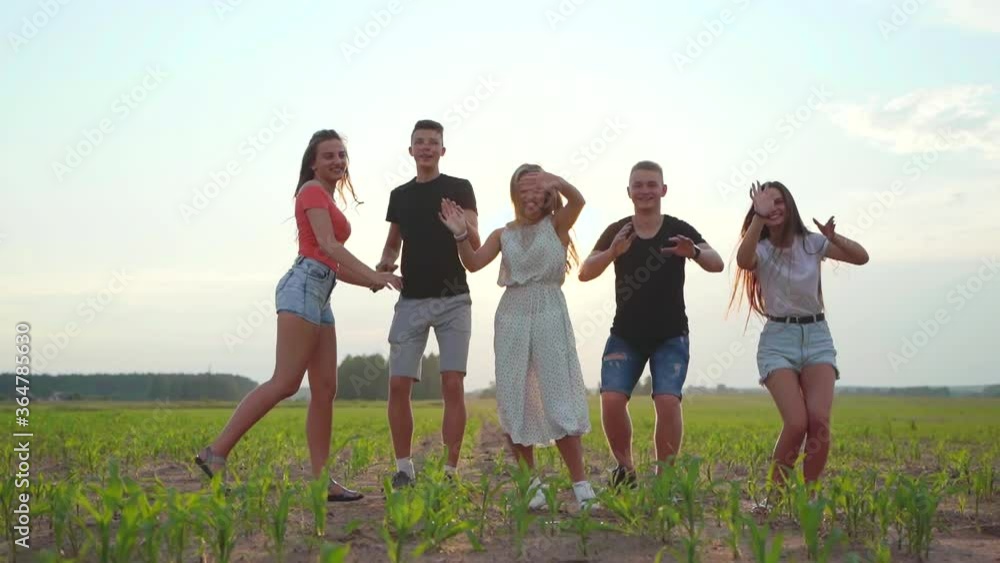 Five happy friends jumping holding hands at sunset. Slow motion video. Slow motion video. Five happy friends jumping holding hands at sunset. Slow motion video. Slow motion video.