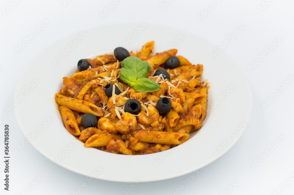 Penne pasta with chicken, olives and vegetables in red tomato sause Penne pasta with chicken, olives and vegetables in red tomato sause