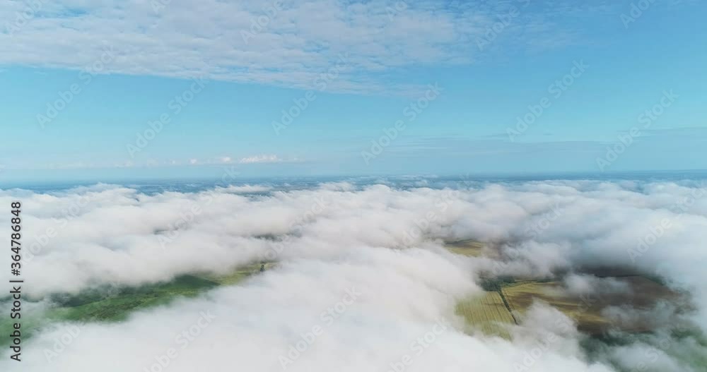 Scenic aerial view of moving white clouds. The drone is flying high in the blue sky through the fluffy clouds ahead. Paradise sky. The clouds are moving on camera. Scenic aerial view of moving white clouds. The drone is flying high in the blue sky through the fluffy clouds ahead. Paradise sky. The clouds are moving on camera.