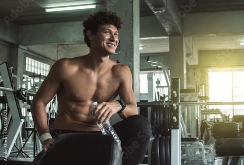 Muscular man doing exercise in gym