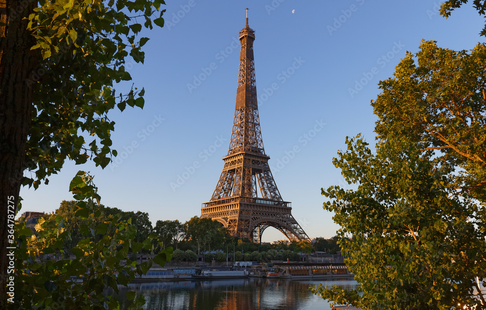 Fototapeta premium Eiffel Tower, iconic Paris landmark with vibrant blue sky
