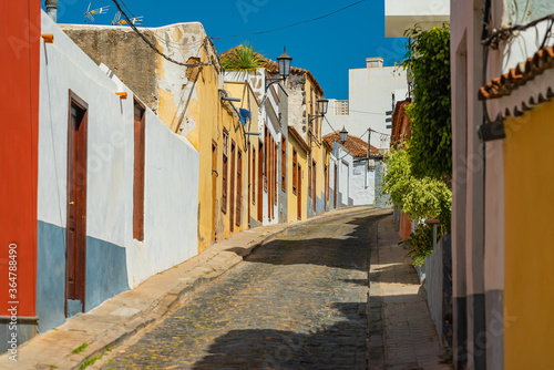 Colorful buildings on a narrow street in spanish town Garachico on a sunny day, Tenerife, Canary islands, Spain.
