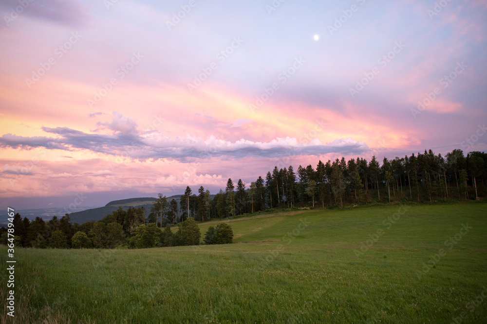 Outstanding evening sky, with magical purple and pink clouds. Countryside dusk landscape, swiss mountains. Outstanding evening sky, with magical purple and pink clouds. Countryside dusk landscape, swiss mountains.