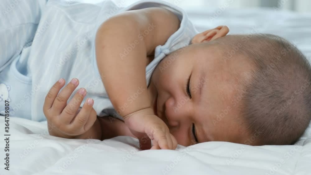 happy baby lying on a bed at home happy baby lying on a bed at home