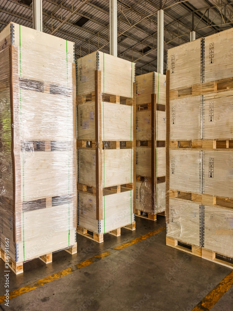 Shipment cartons box on pallets and wooden case on forklift in interior warehouse cargo for export and sorting goods in freight logistics and transportation industrial Shipment cartons box on pallets and wooden case on forklift in interior warehouse cargo for export and sorting goods in freight logistics and transportation industrial