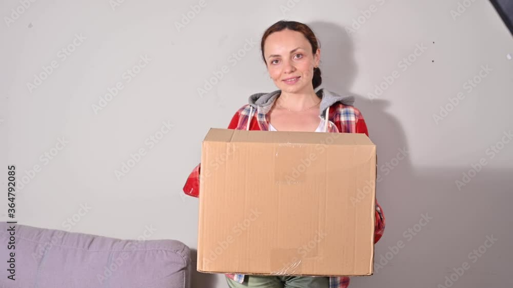 Unpacking the parcel. A woman holds a large paper box in her hands, a parcel. Successful Mailing Concept , service for home and business. mockup. Place for text. 4k footage, focus on the box Unpacking the parcel. A woman holds a large paper box in her hands, a parcel. Successful Mailing Concept , service for home and business. mockup. Place for text. 4k footage, focus on the box