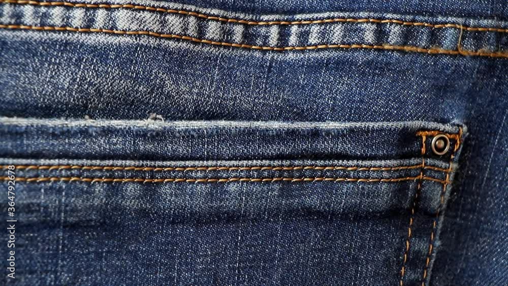 Professional thief takes money from the back pocket of jeans. Stealing dollars from pants. Professional thief takes money from the back pocket of jeans. Stealing dollars from pants.