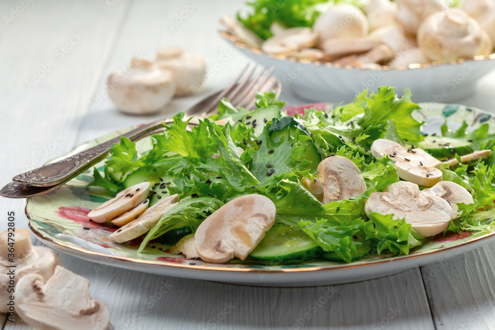 Salad of cucumbers, green salad and raw mushrooms. Salad of cucumbers, green salad and raw mushrooms.