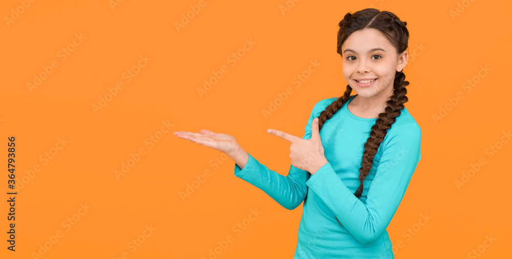 stylish braids and pigtails. copy space. teenage girl presenting product. professional hairdo. kid fashion and beauty. small girl after hairdresser. childhood happiness. beautiful braided long hair stylish braids and pigtails. copy space. teenage girl presenting product. professional hairdo. kid fashion and beauty. small girl after hairdresser. childhood happiness. beautiful braided long hair