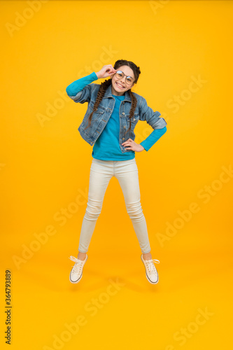 keep moving. happy hipster girl jumping. enjoy your life. happy childrens day. cool girl in the air. sense of freedom. smiling kid wear glasses. energy is her inner power © be free