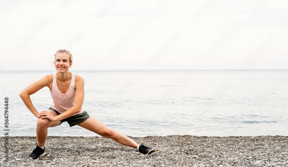 Blong athlete woman doing exercises at the beach Blong athlete woman doing exercises at the beach