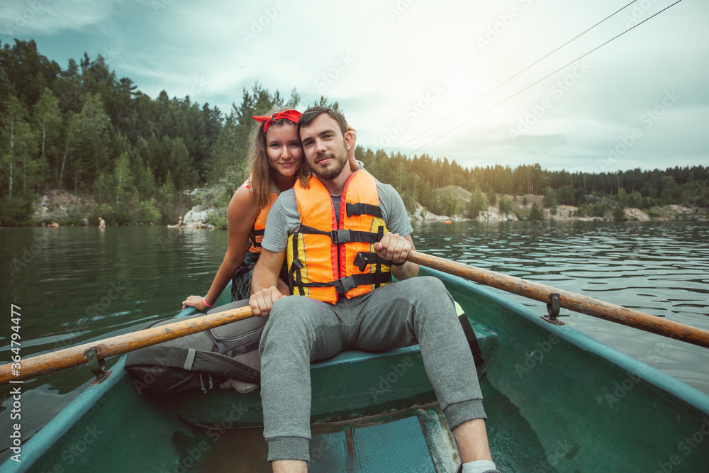 A portrait of a happy copule in a canoe on a glacial lake