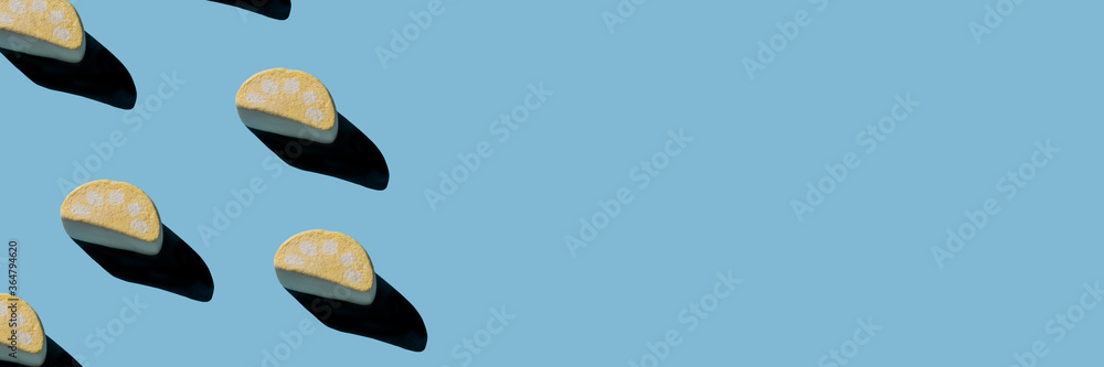 Several tasty marshmallows with hard shadows on a light blue background. Several tasty marshmallows with hard shadows on a light blue background.
