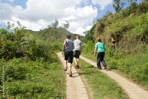Boys walking along a mountain trail in Brazil © SMaggi