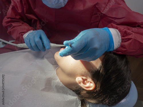 Operation with dental or dental hygienist patient. Woman with calculus or bruise. Oral Doctor wisdom tooth removal. Dentist. Expert business.