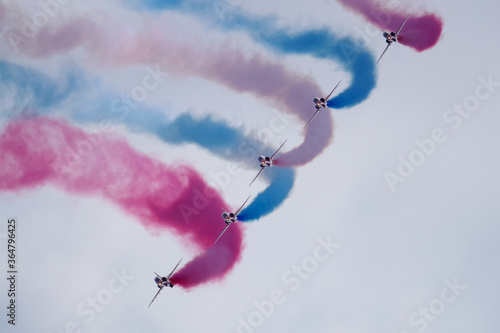 The Red Arrows making a sharp turn in formation.