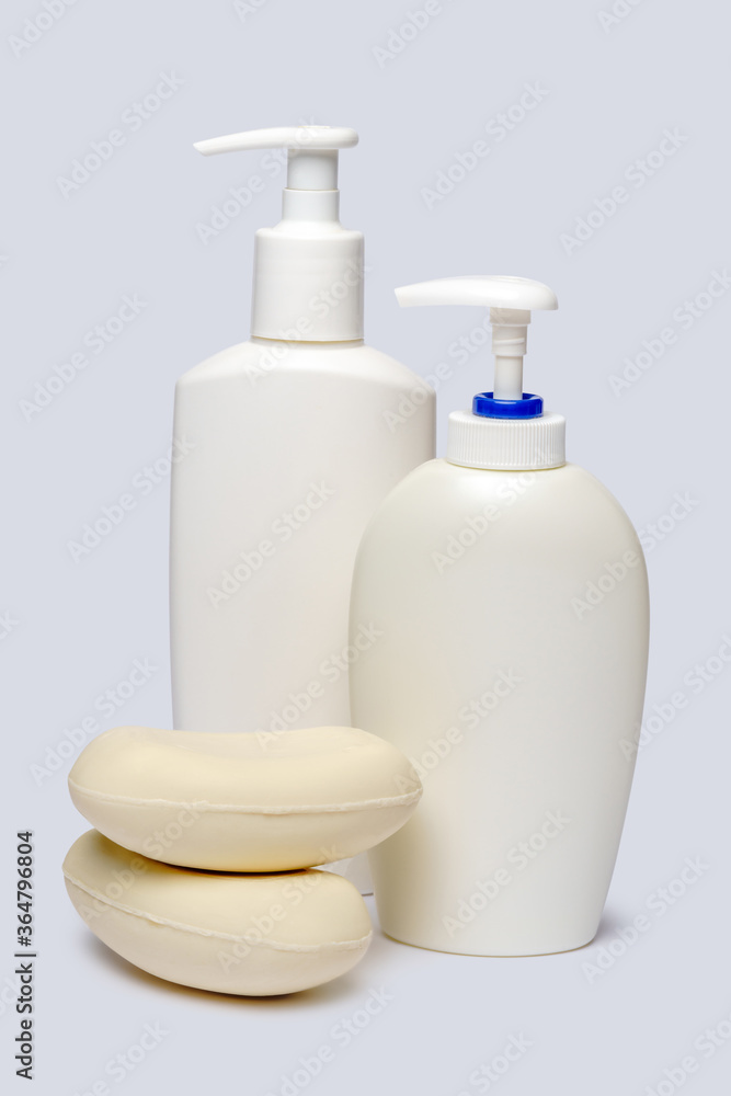 piece of soap and bottle of liquid soap over light grey backgound with clipping path piece of soap and bottle of liquid soap over light grey backgound with clipping path