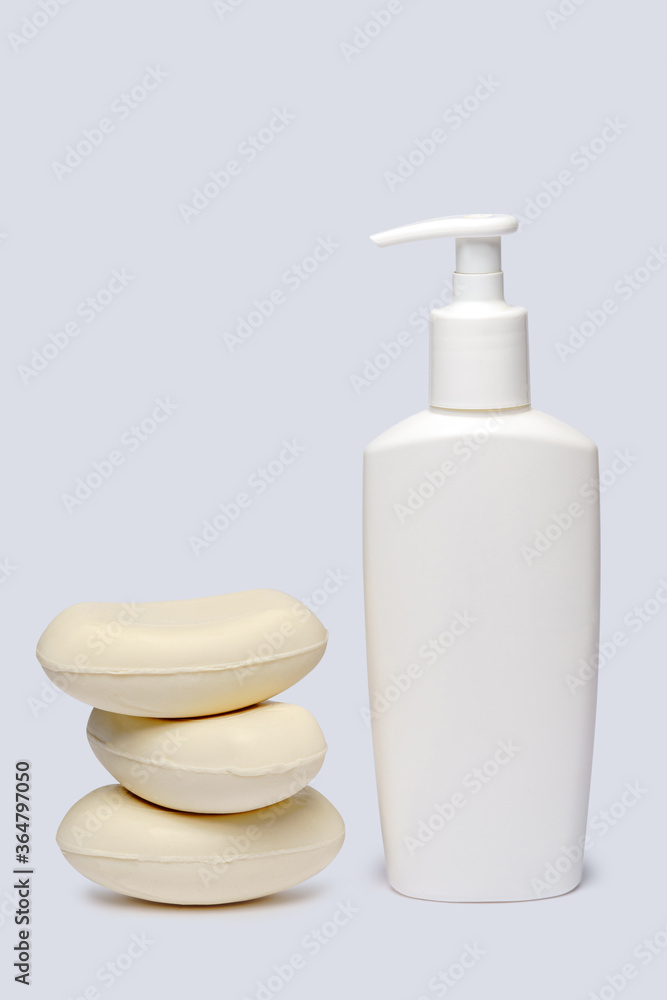 piece of soap and bottle of liquid soap over light grey backgound with clipping path piece of soap and bottle of liquid soap over light grey backgound with clipping path