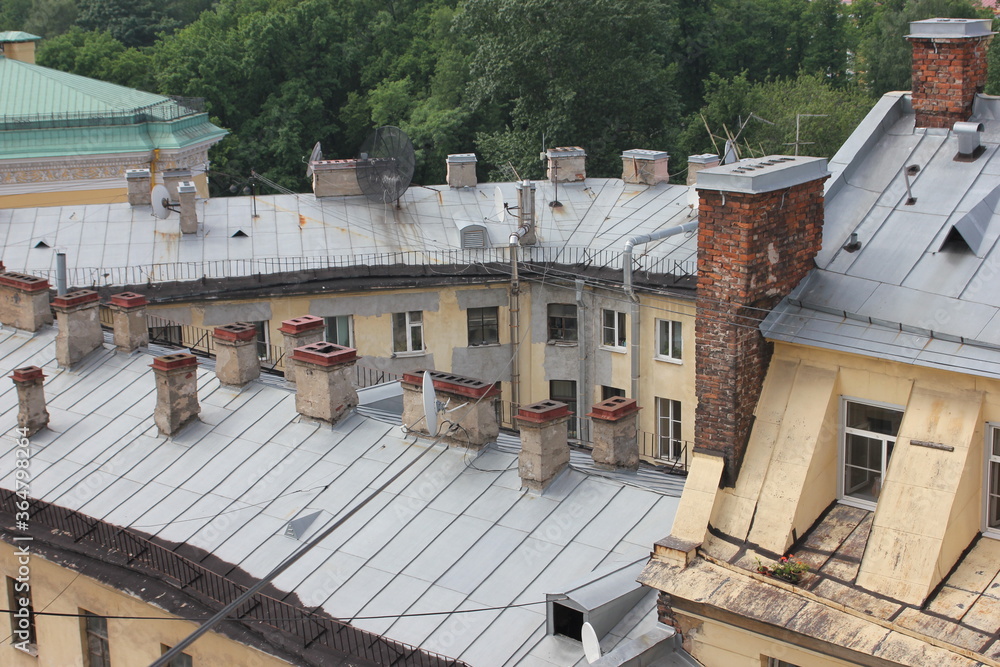 Saint-Petersburg, Russia - 10.06.20. Cityscape panorama of old central city part, view from a roof. Famous rooftops of St. Petersburg with Saint Isaac's Cathedralat the background. Saint-Petersburg, Russia - 10.06.20. Cityscape panorama of old central city part, view from a roof. Famous rooftops of St. Petersburg with Saint Isaac's Cathedralat the background.