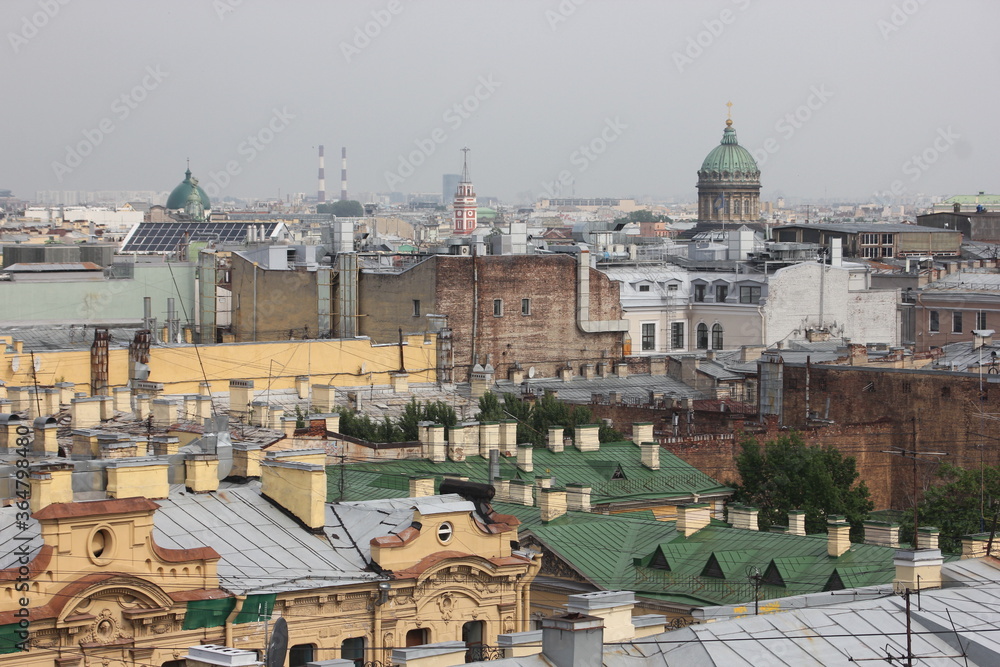 Fototapeta premium Saint-Petersburg, Russia - 10.06.20. Cityscape panorama of old central city part, view from a roof. Famous rooftops of St. Petersburg with Saint Isaac's Cathedralat the background.
