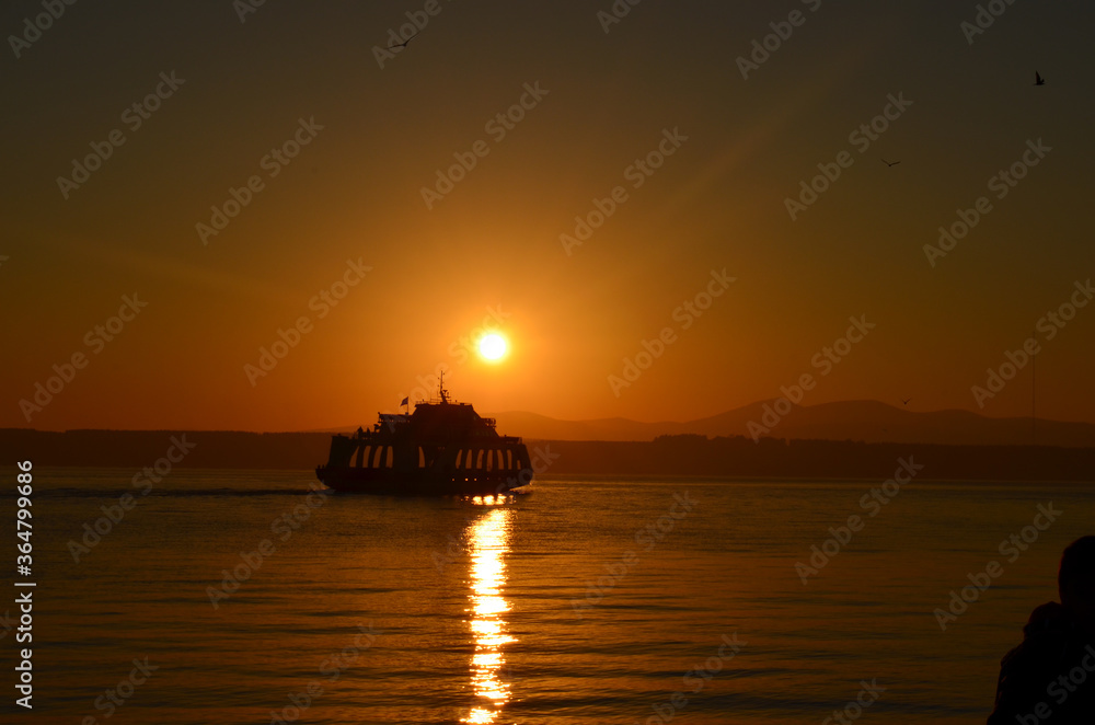 Canakkale with a sunrise and a steamer, morning hours, red colors, sunrise, orange, red, yellow colors
