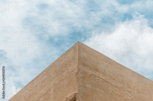 View of the edge of a building wall against the blue sky