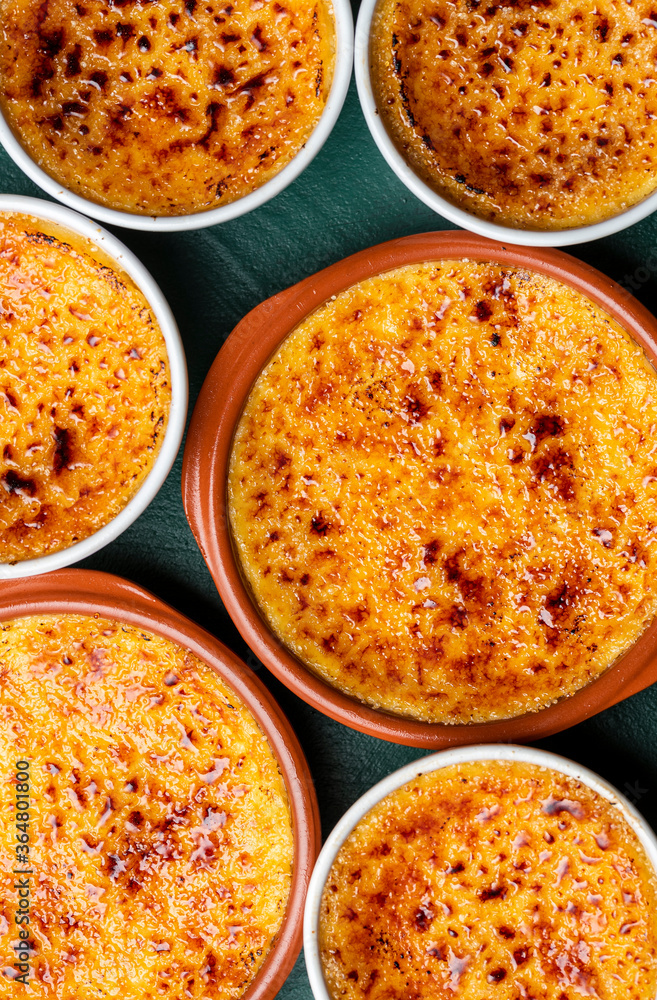 Creme brulee top view close-up. Bowls with burned cream and caramelized sugar Creme brulee top view close-up. Bowls with burned cream and caramelized sugar