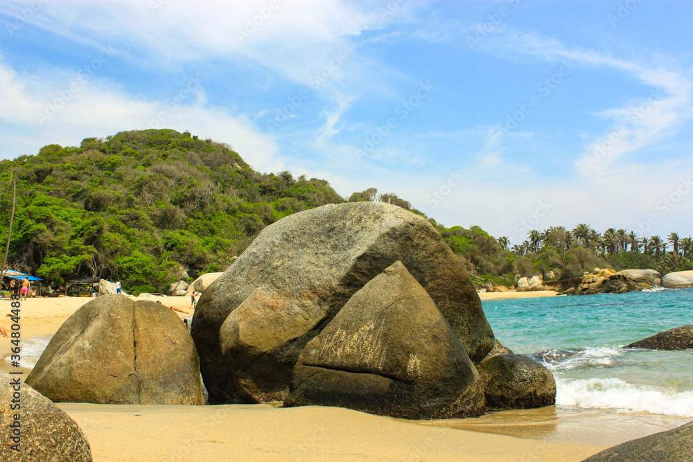 Caribbean sea with white sand beach surrounded by tropical forest in Tayrona National Park in Cabo San Juan del Guia, Colombia. Caribbean sea with white sand beach surrounded by tropical forest in Tayrona National Park in Cabo San Juan del Guia, Colombia.