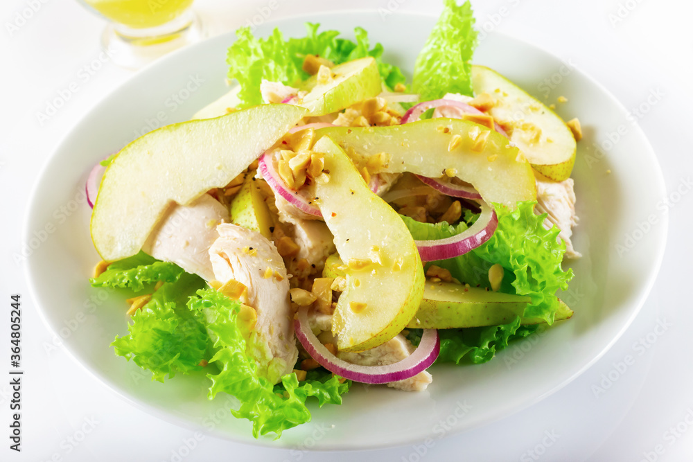 Healthy food. Chicken fillet salad with pear and orange sauce. White background. High key. Selective focus. Healthy food. Chicken fillet salad with pear and orange sauce. White background. High key. Selective focus.