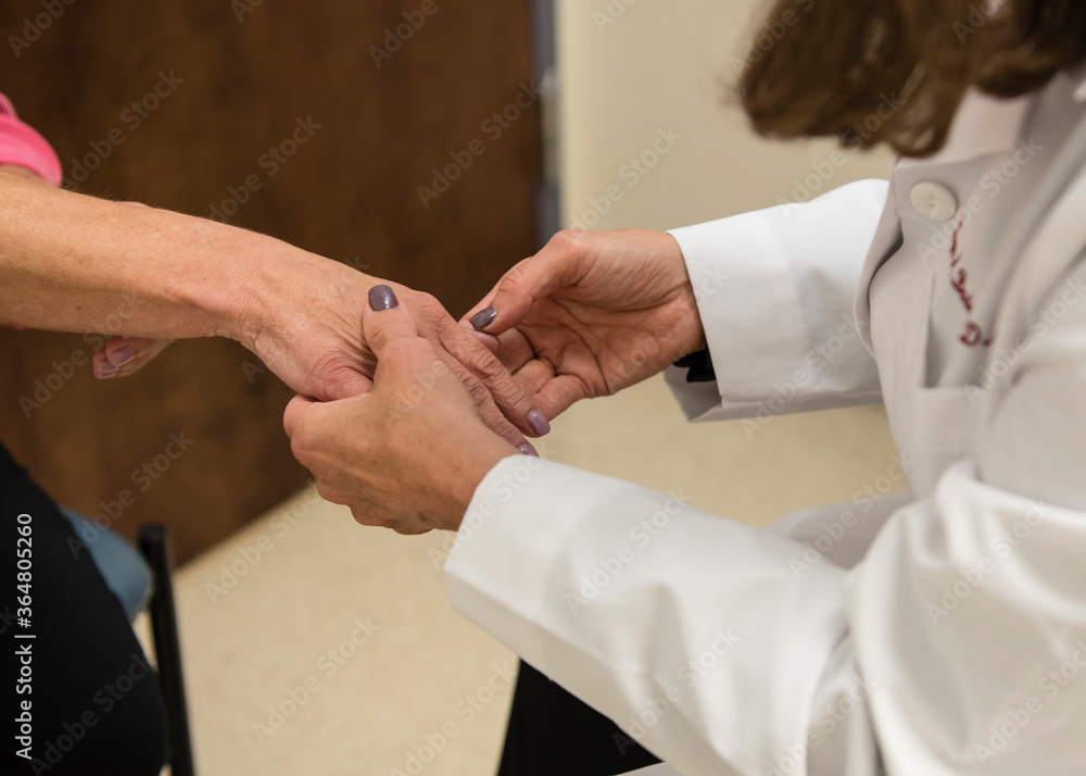 Dermatologist examining patient's skin Dermatologist examining patient's skin