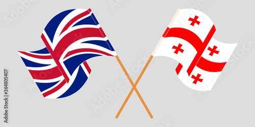 Crossed and waving flags of Georgia and the UK