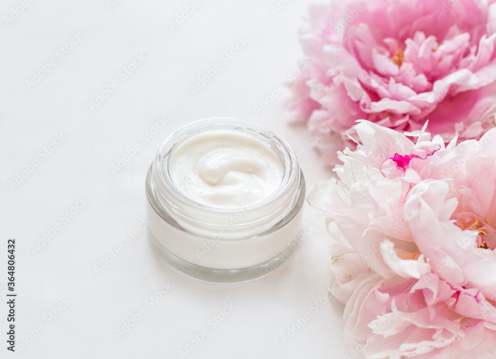Jar of skin care cream and pink peonies Jar of skin care cream and pink peonies